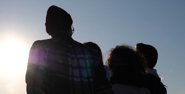 Silhouette Group of Happy Teenagers Walking in the sun