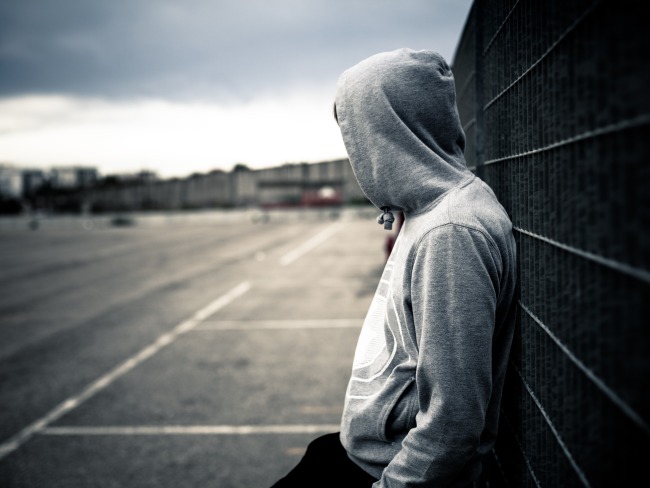 Man Leaning on a Fence